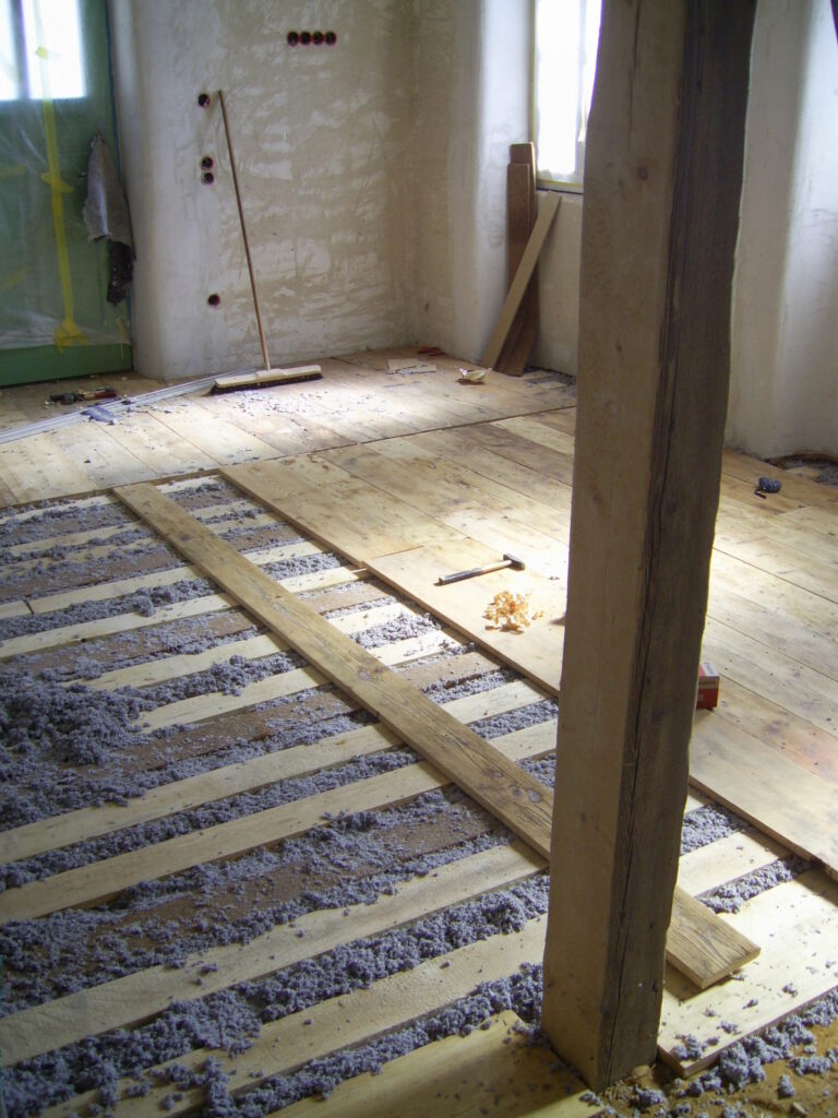 Boden mit Kreuzlattung und teilweise verlegten Massivholzdielen