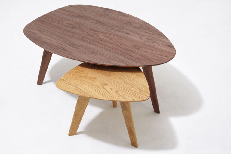 Couchtisch in Bootsform in dunklem Holz und kleinerer, dreieckiger Couchtisch in hellem Holz